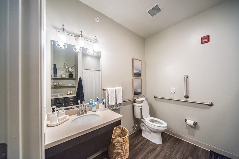 Private senior bathroom at Charter Senior Living of Paducah, KY, with modern fixtures, a walk-in shower, and safety grab bars for accessibility.