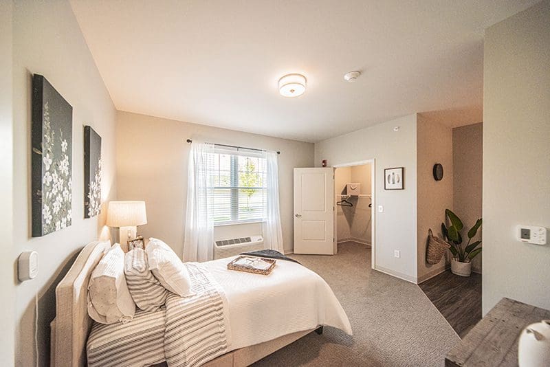 Spacious senior apartment kitchen and living area with stainless steel appliances at Charter Senior Living of Paducah