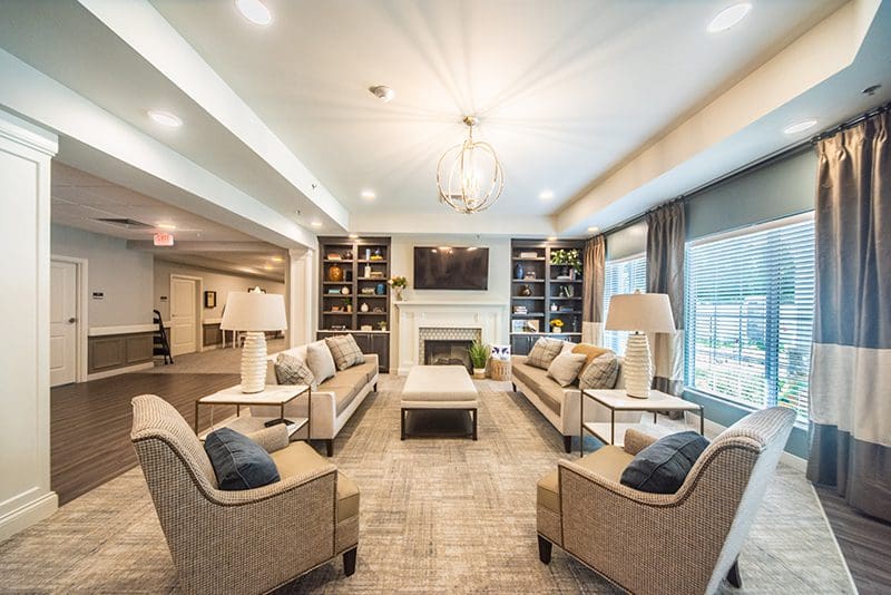 Comfortable senior lounge with fireplace and armchairs at Charter Senior Living of Paducah, KY