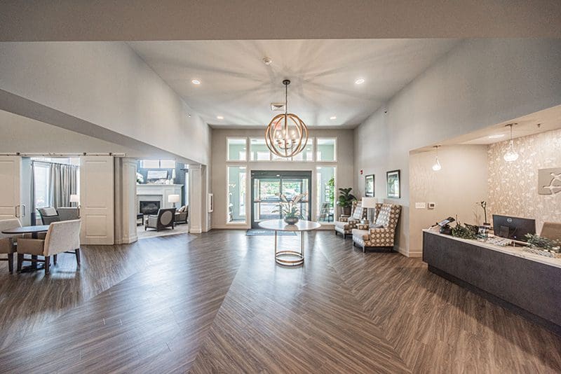 Spacious and welcoming lobby at Charter Senior Living of Paducah, KY, featuring a modern reception desk, stylish seating, and elegant decor to greet residents and visitors.
