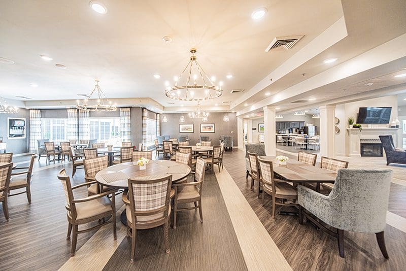 Elegant dining area at Charter Senior Living of Paducah, KY, featuring modern lighting, spacious seating, and a welcoming atmosphere for residents to enjoy chef-prepared meals.